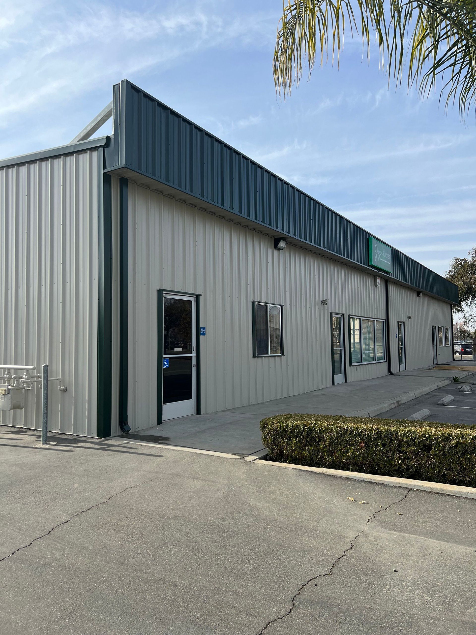 Shopping center building exterior painted using PPG Pitt-Tech Plus DTM in satin sheen 