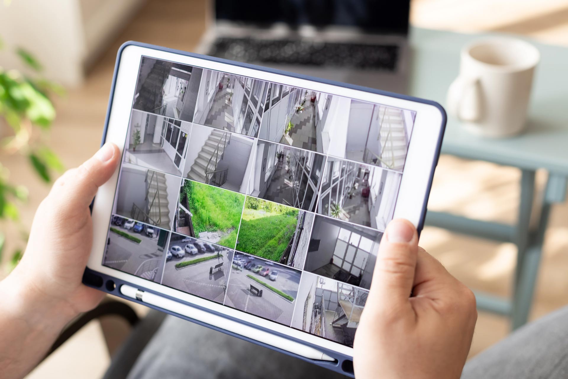 Man-monitoring-modern-cctv-cameras-on-digital-tablet