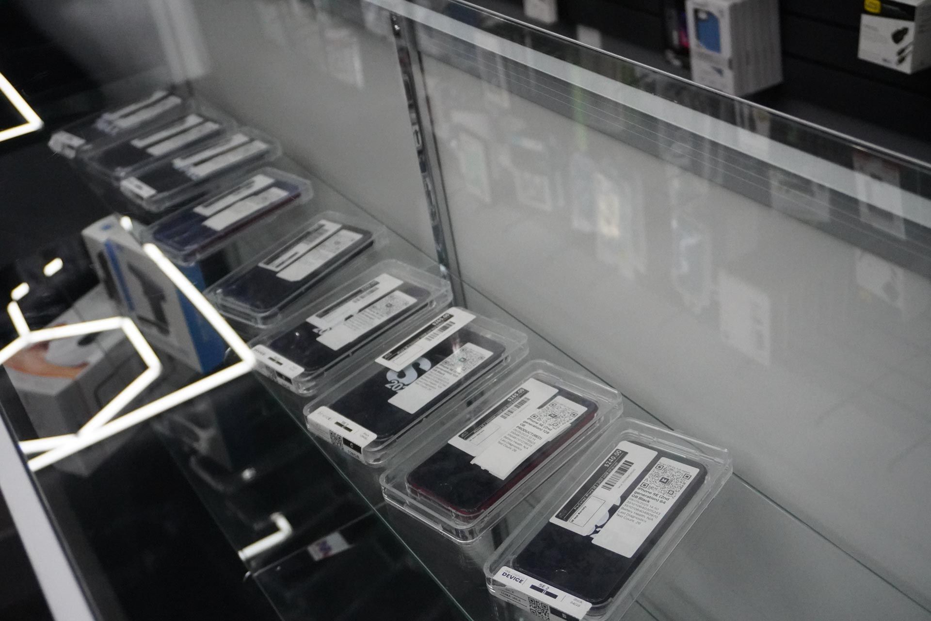 A display case filled with a variety of cell phones