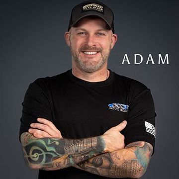 a man with tattoos on his arms is wearing a hat and a black shirt .