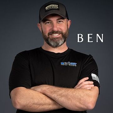 a man with a beard wearing a hat and a black shirt with the name ben on the bottom