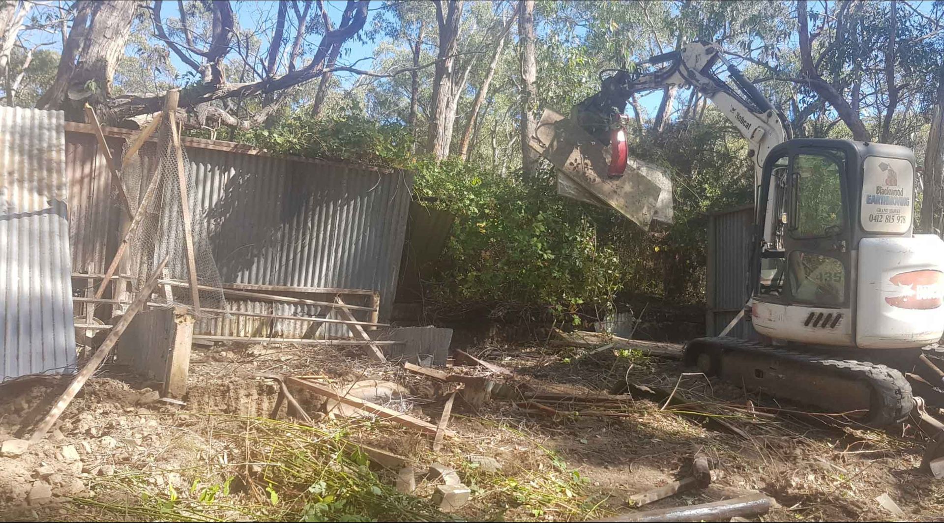 A Bulldozer Is Demolishing A Shed In The Woods – Blackwood SA - Blackwood Earthmoving
