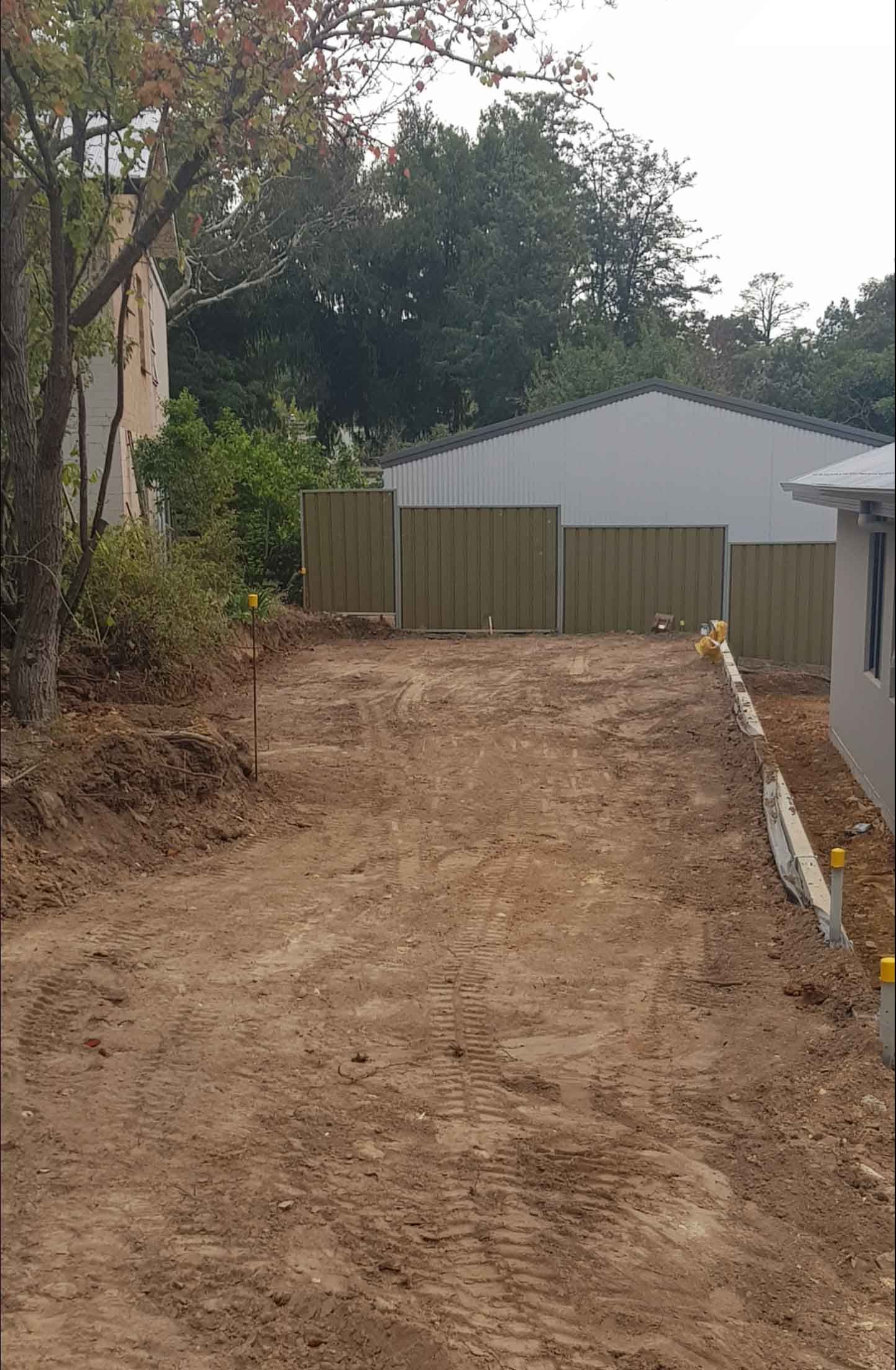 A Dirt Road Leading To A House With A Fence In The Background – Blackwood SA - Blackwood Earthmoving