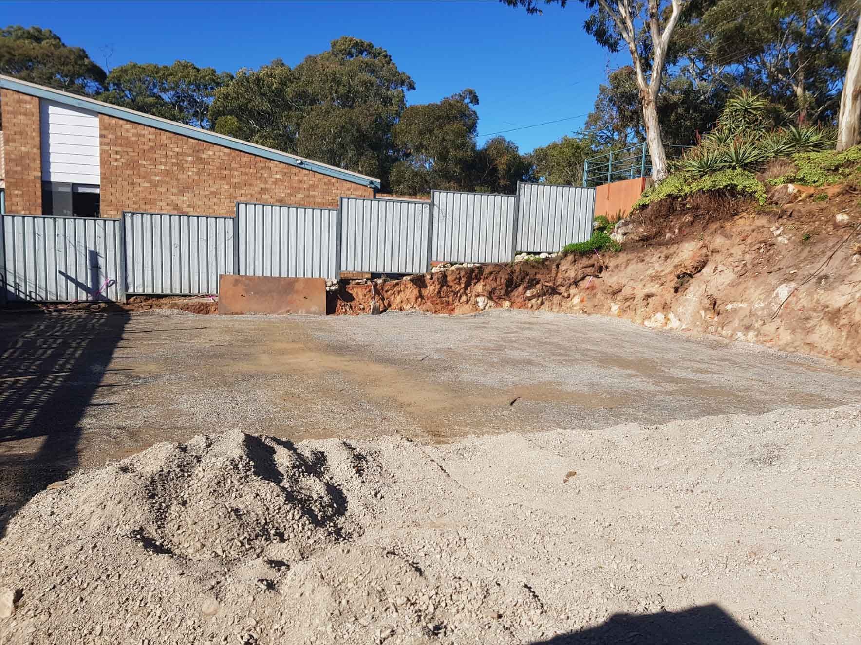 A Pile Of Gravel Is Sitting In Front Of A Brick Building – Blackwood SA - Blackwood Earthmoving