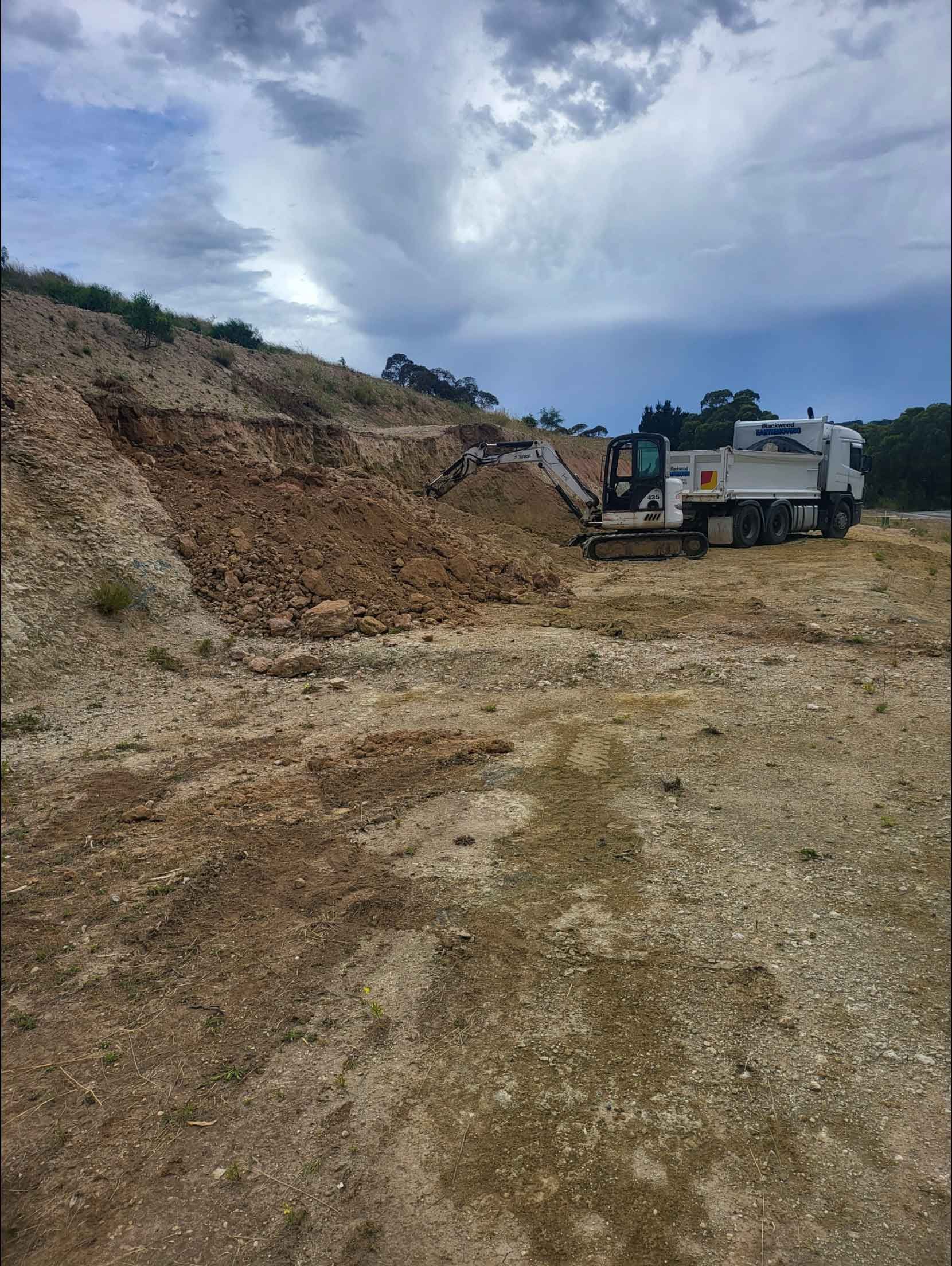 A Large Pile Of Dirt Is Being Loaded Into A Dump Truck – Blackwood SA - Blackwood Earthmoving