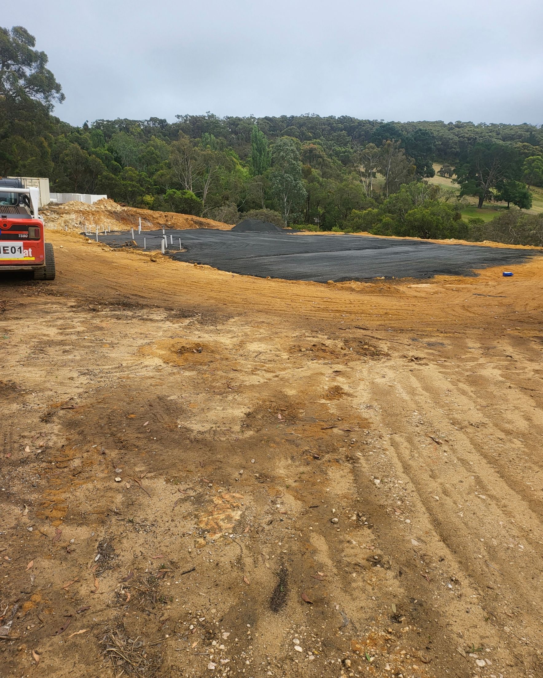 A Red Truck Is Parked In The Middle Of A Dirt Field – Blackwood SA - Blackwood Earthmoving