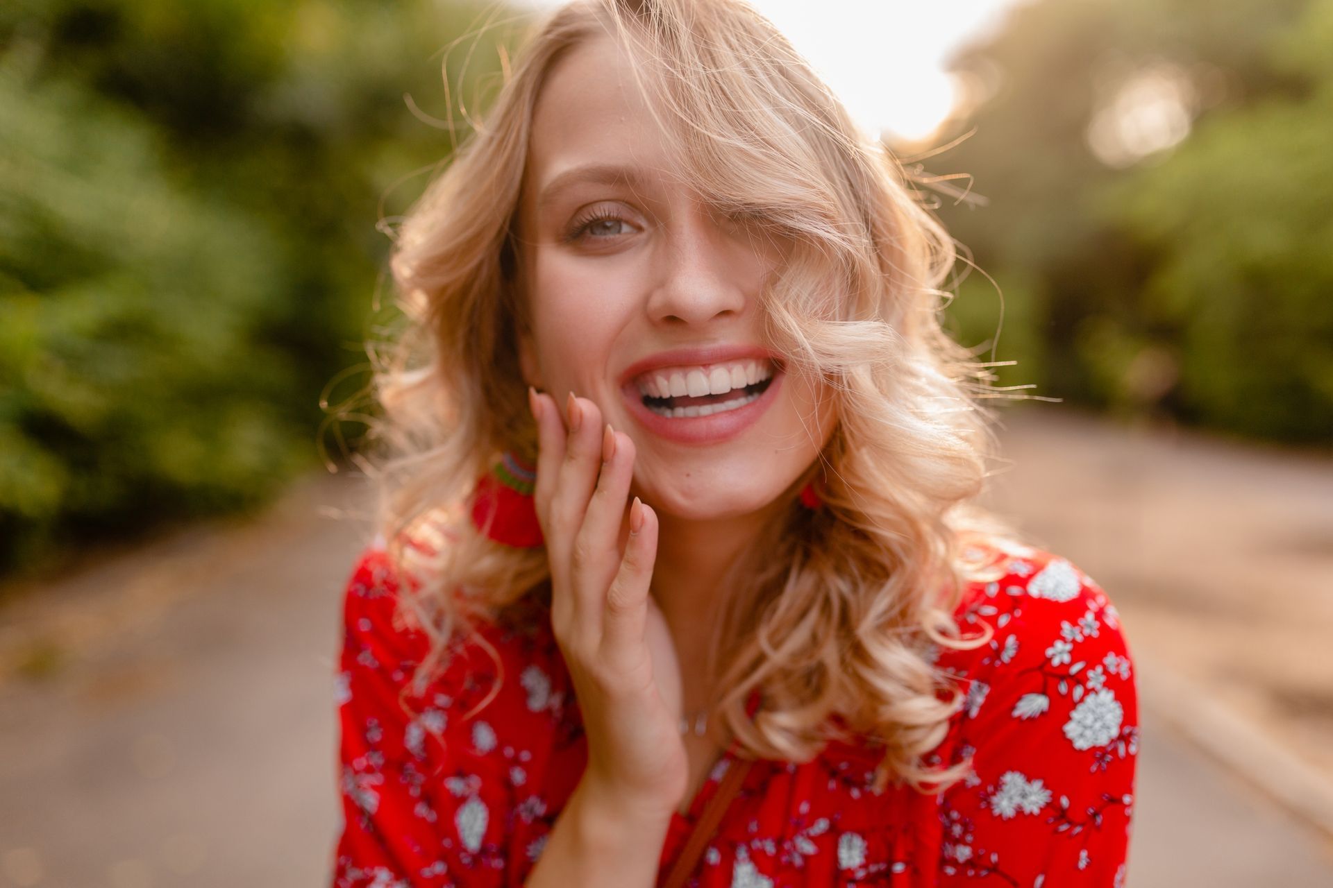 A close up of a woman 's face with blonde hair and red lipstick