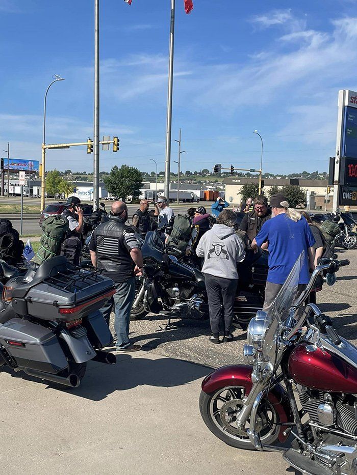 biker huddled by gas station