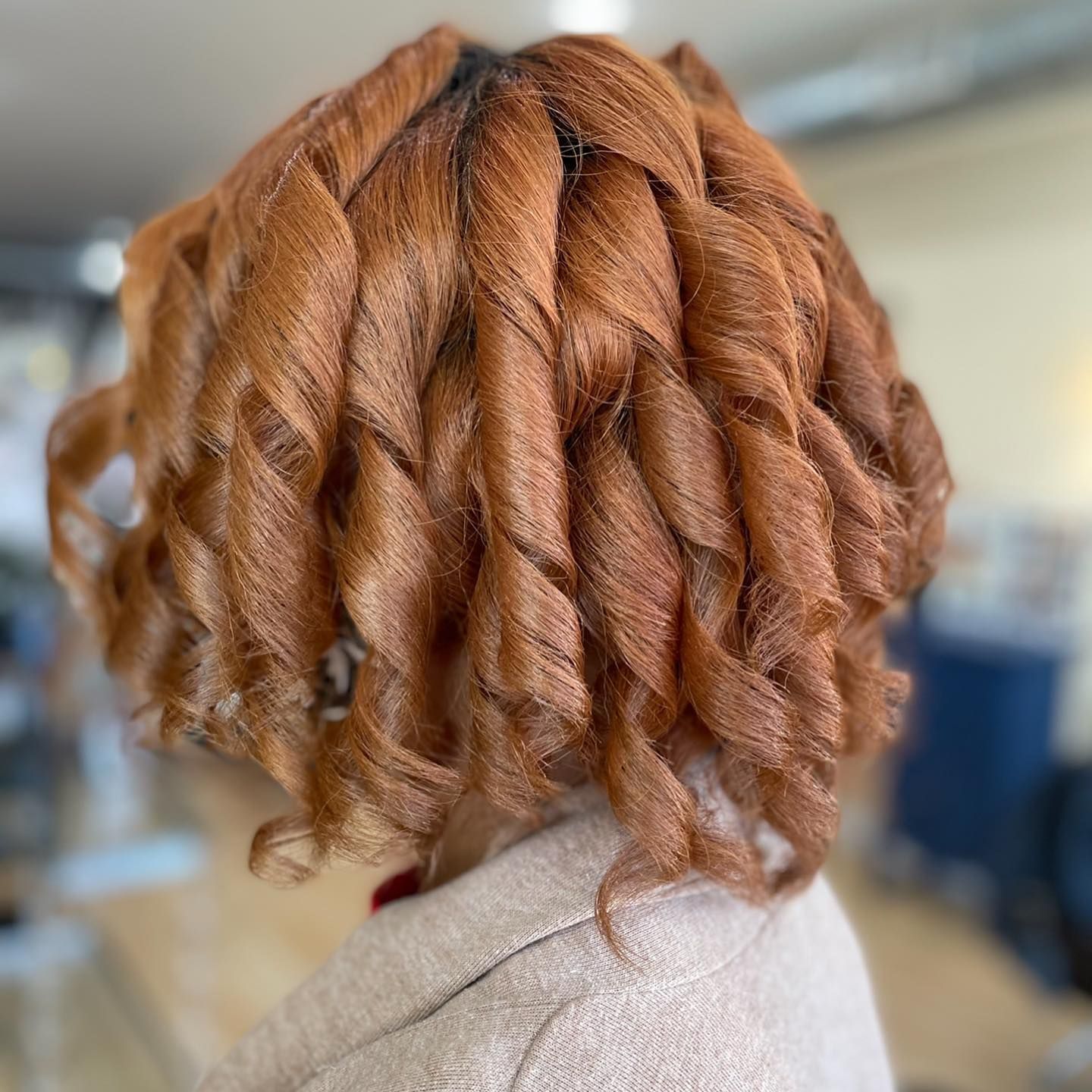 A woman with red hair has her hair in a braid.