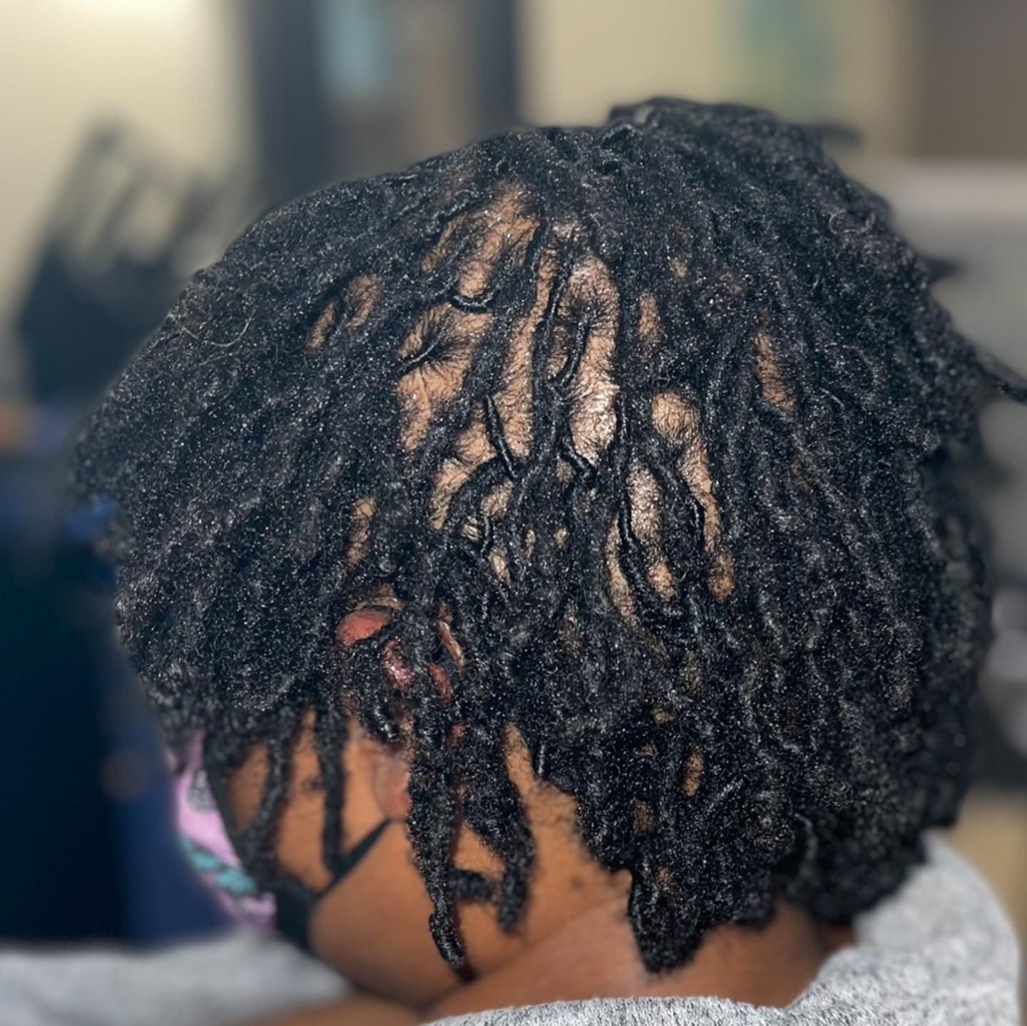 A close up of a person 's hair with dreadlocks