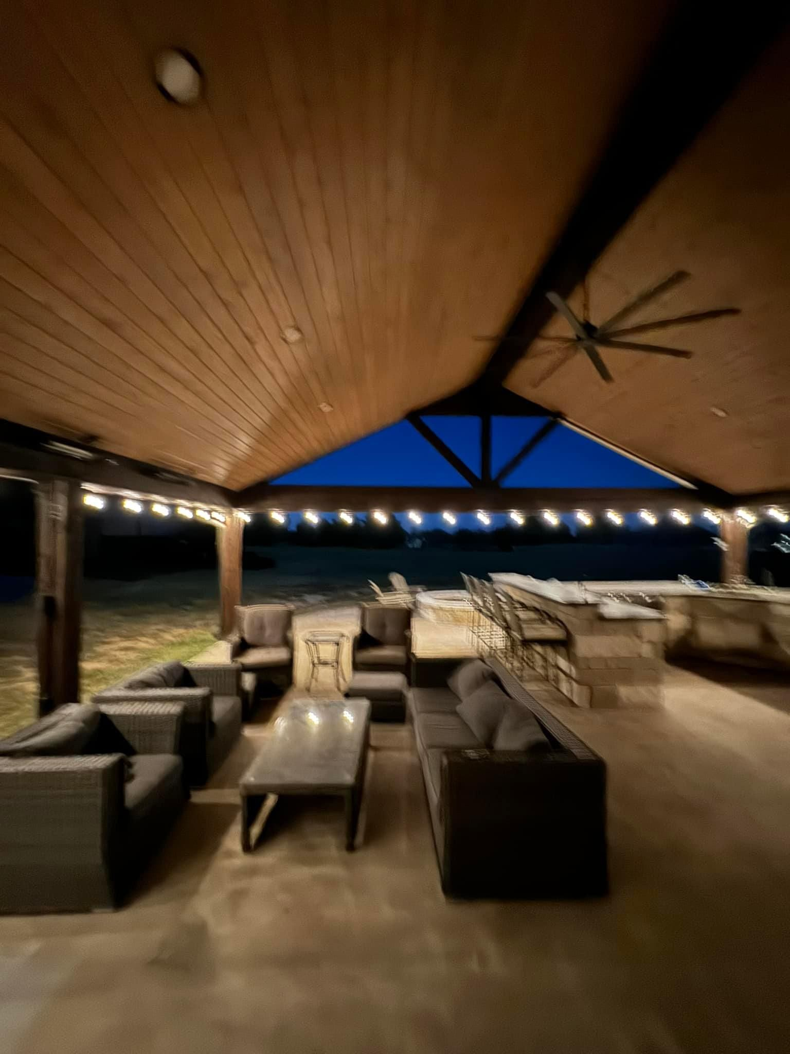 A living room with a lot of furniture and a ceiling fan