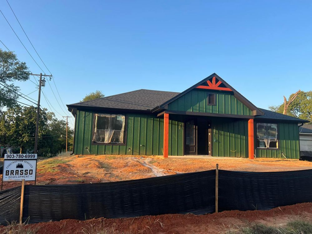 A house that is being built with a sign in front of it