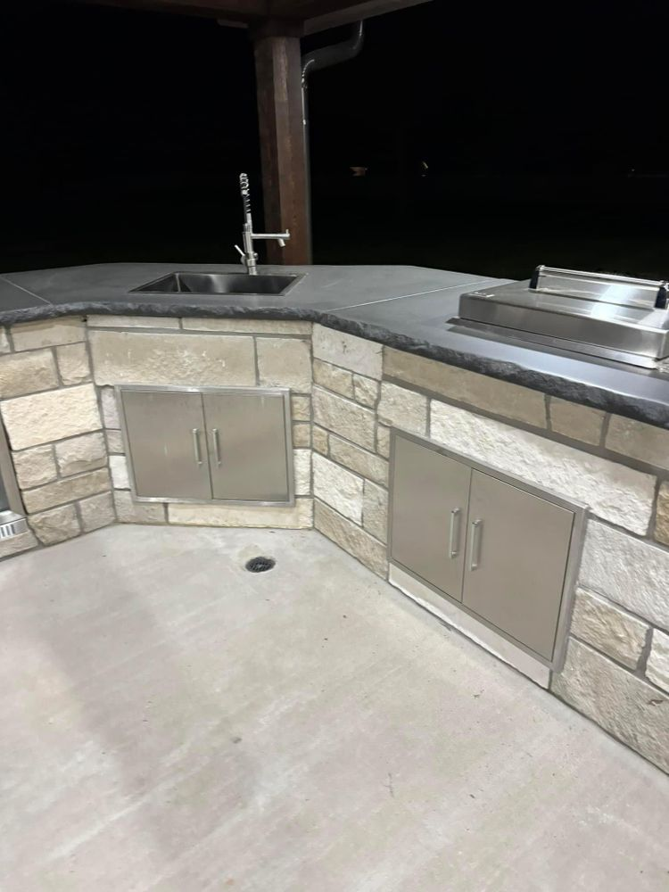 There is a sink and a grill in the kitchen.