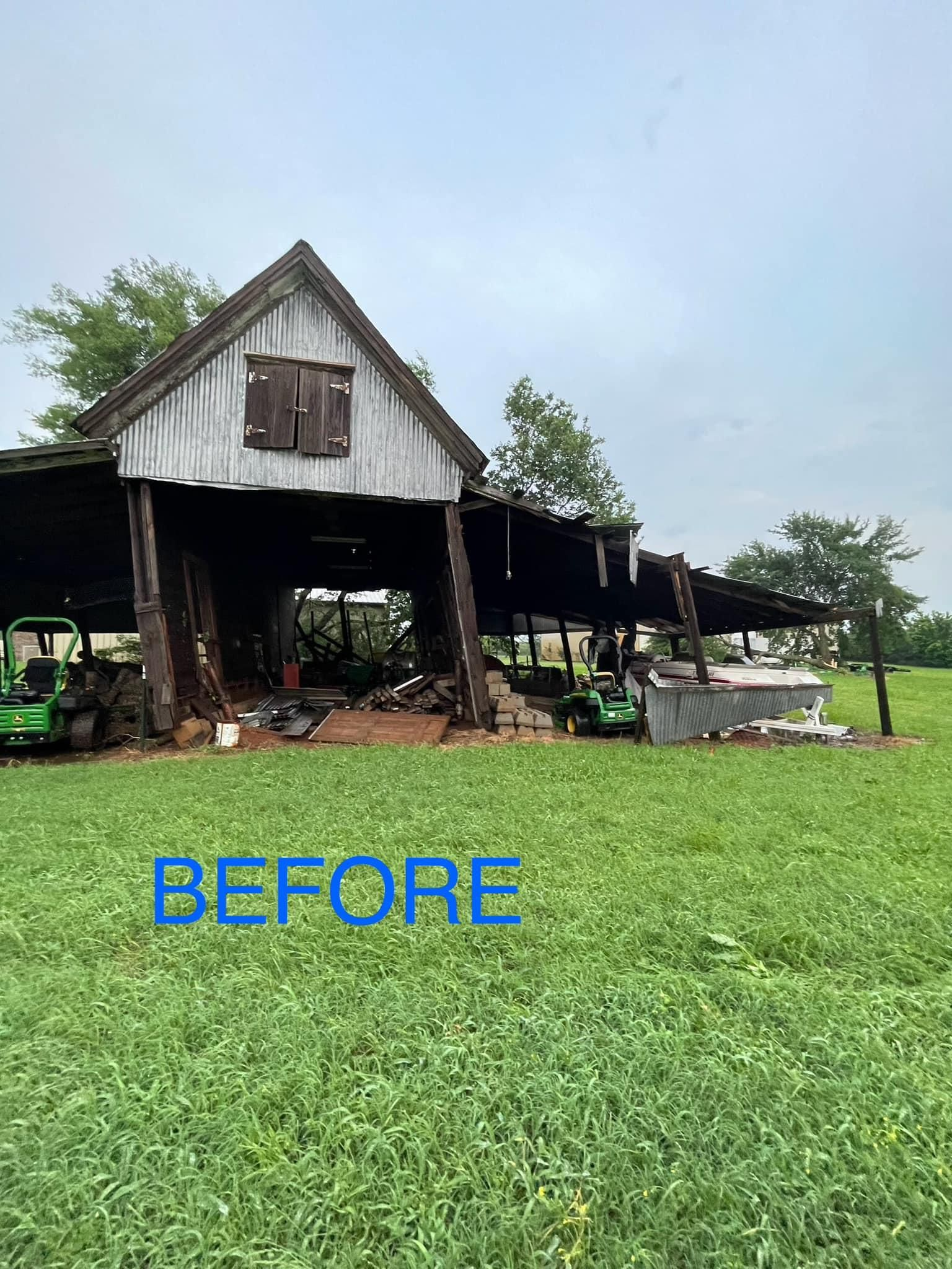 A barn is sitting in the middle of a grassy field.