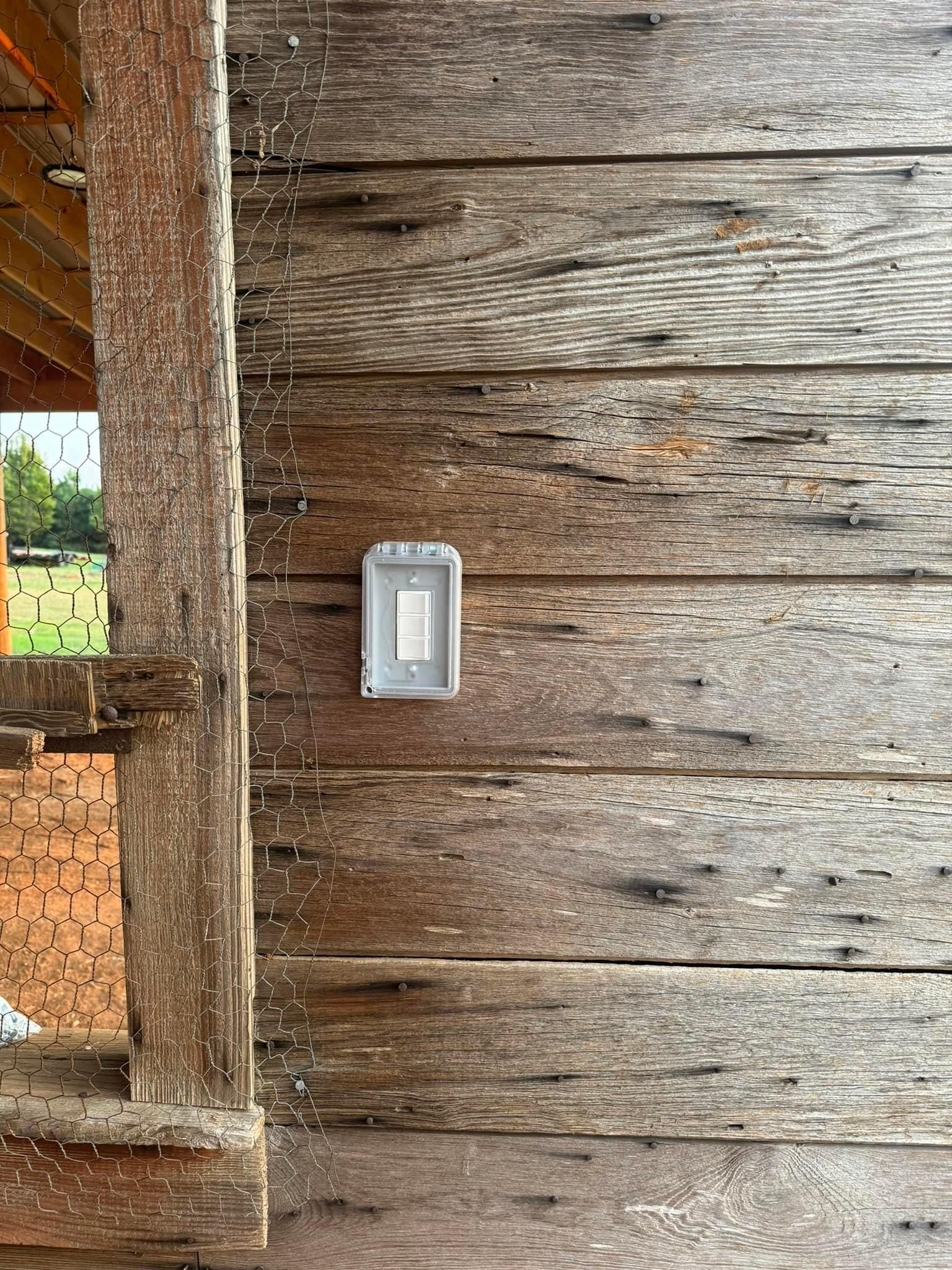 A wooden wall with a light switch on it.