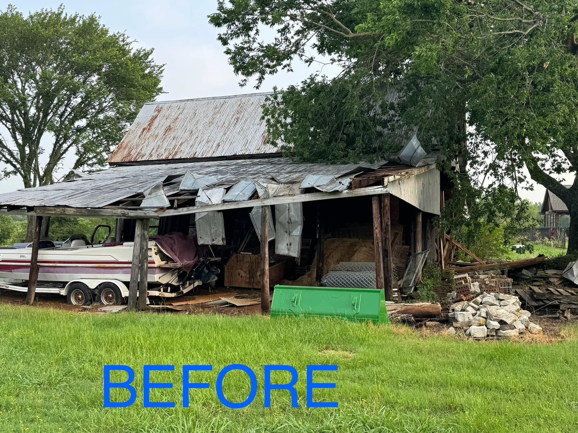A before picture of a barn with a boat in it.