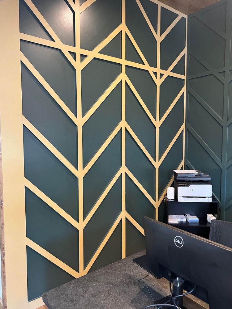 A dell computer is sitting in front of a green wall