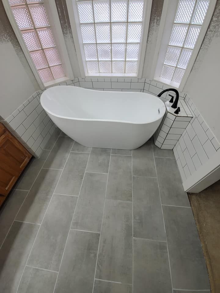 There is a bathtub in the middle of the bathroom.