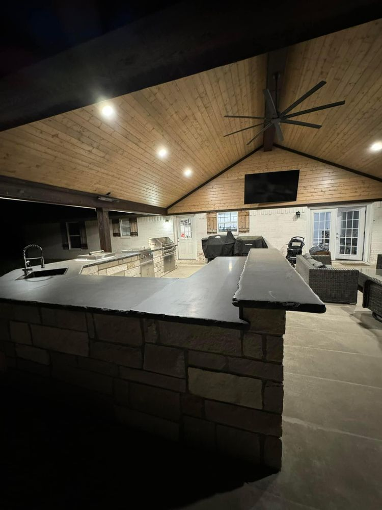 A kitchen with a brick counter top and a ceiling fan.