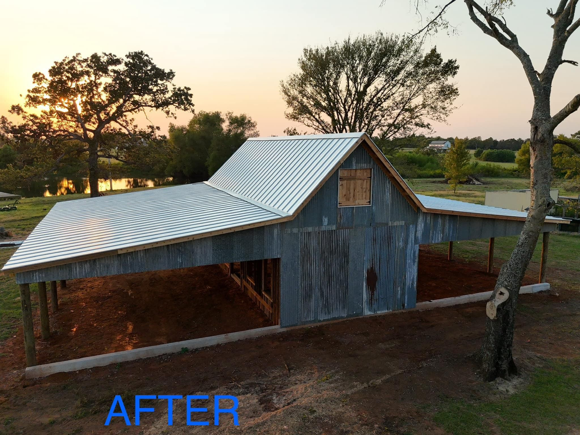 A picture of a barn with a metal roof after being built