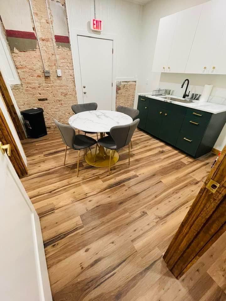 A kitchen with a round table and chairs and a sink.