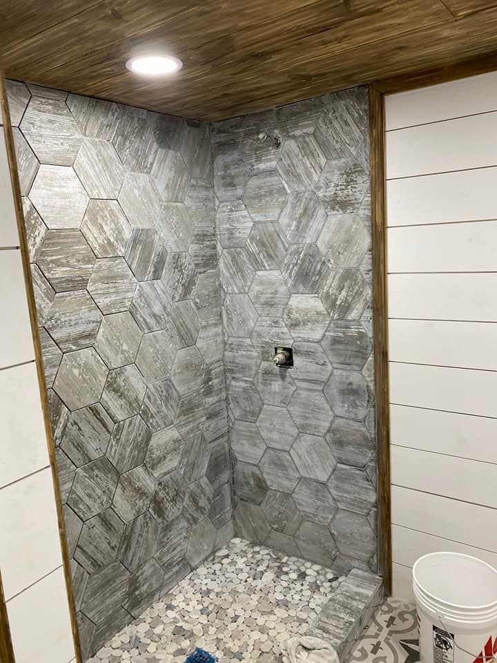 A bathroom with a walk in shower and a toilet.