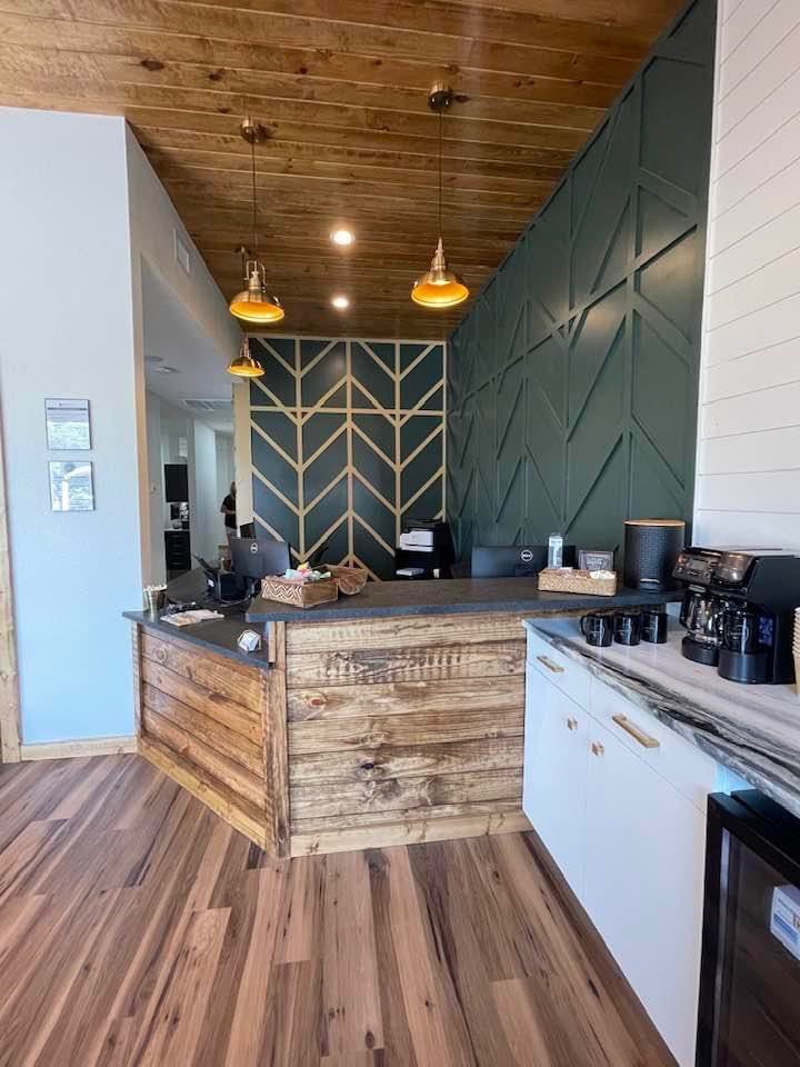 A kitchen with a wooden counter and a green wall.