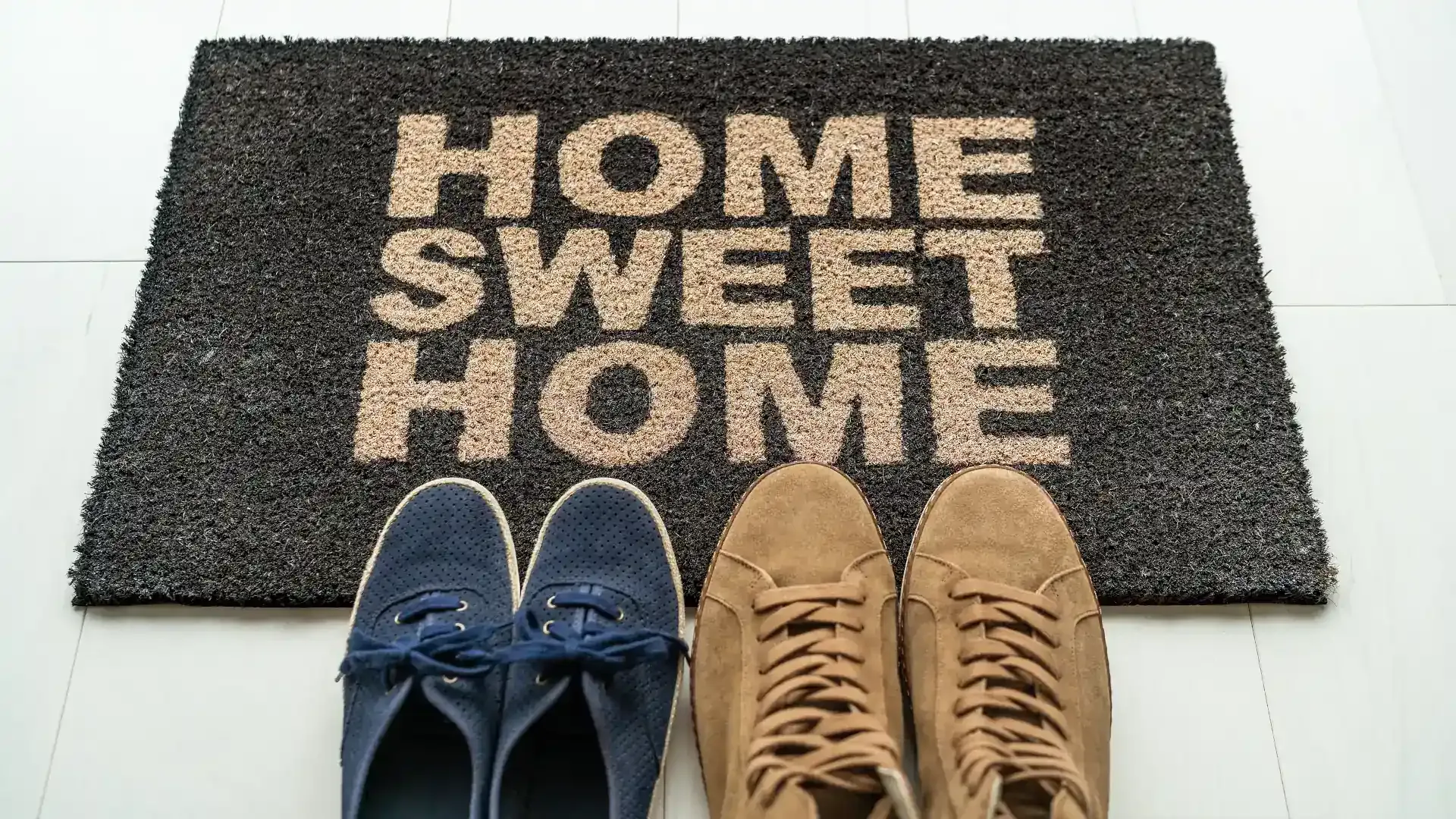 Pair of shoes on a rug with text home sweet home signifying tenant retention