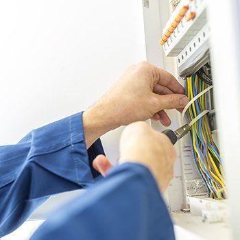 Electrician installing an electrical fuse box