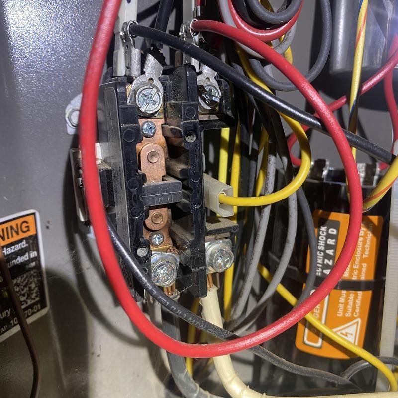 Electrical panel with wires, including red, yellow, and gray. Black contactor visible.