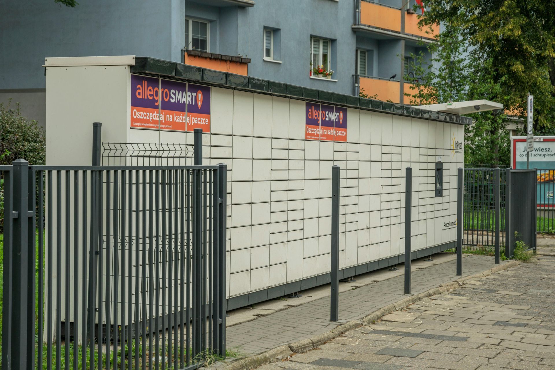 A fence surrounds a building.