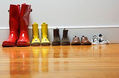 Boots and Shoes on Wood Floor - Wood Floor Repair in Iowa City, IA