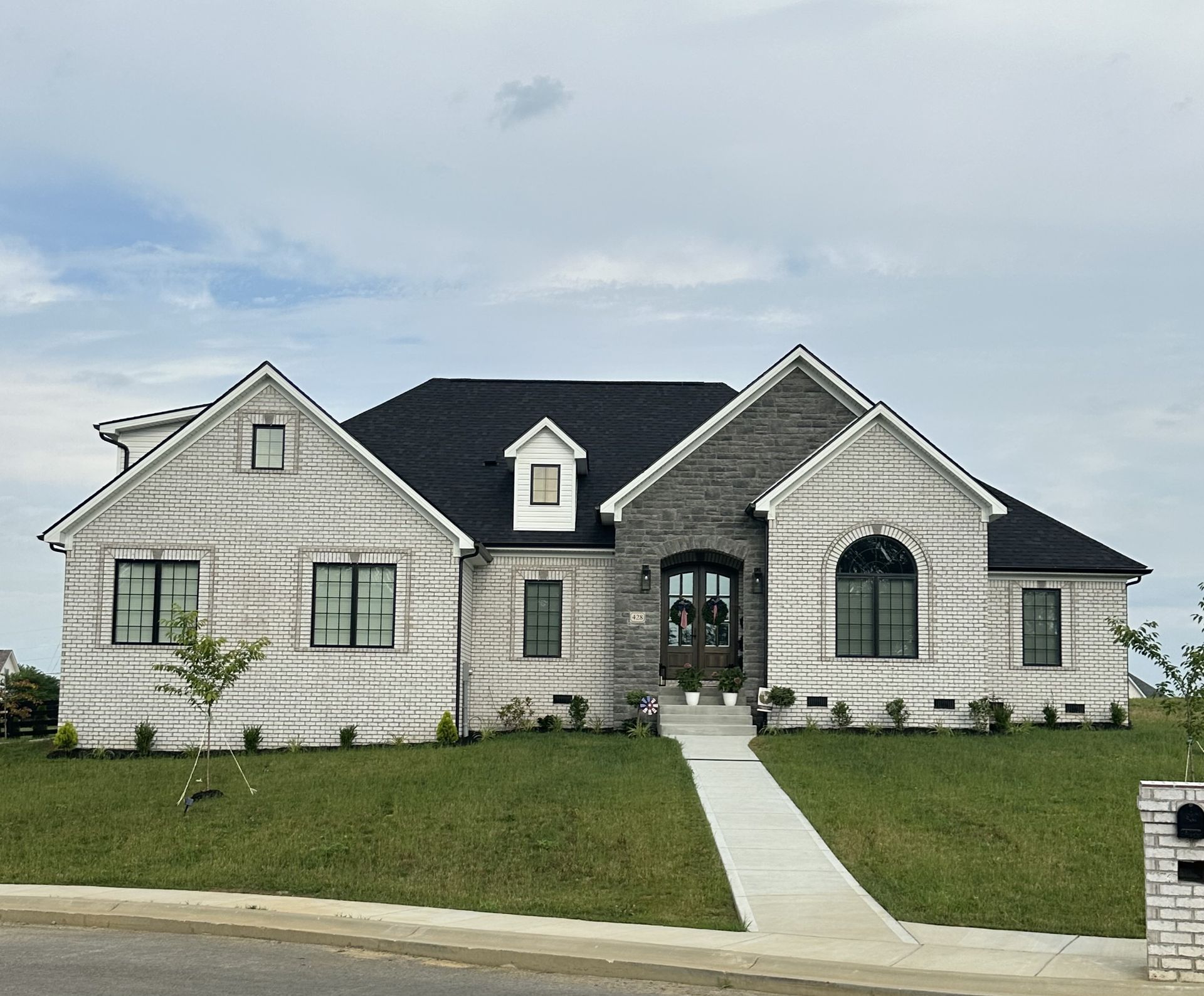 A large white house with a black roof