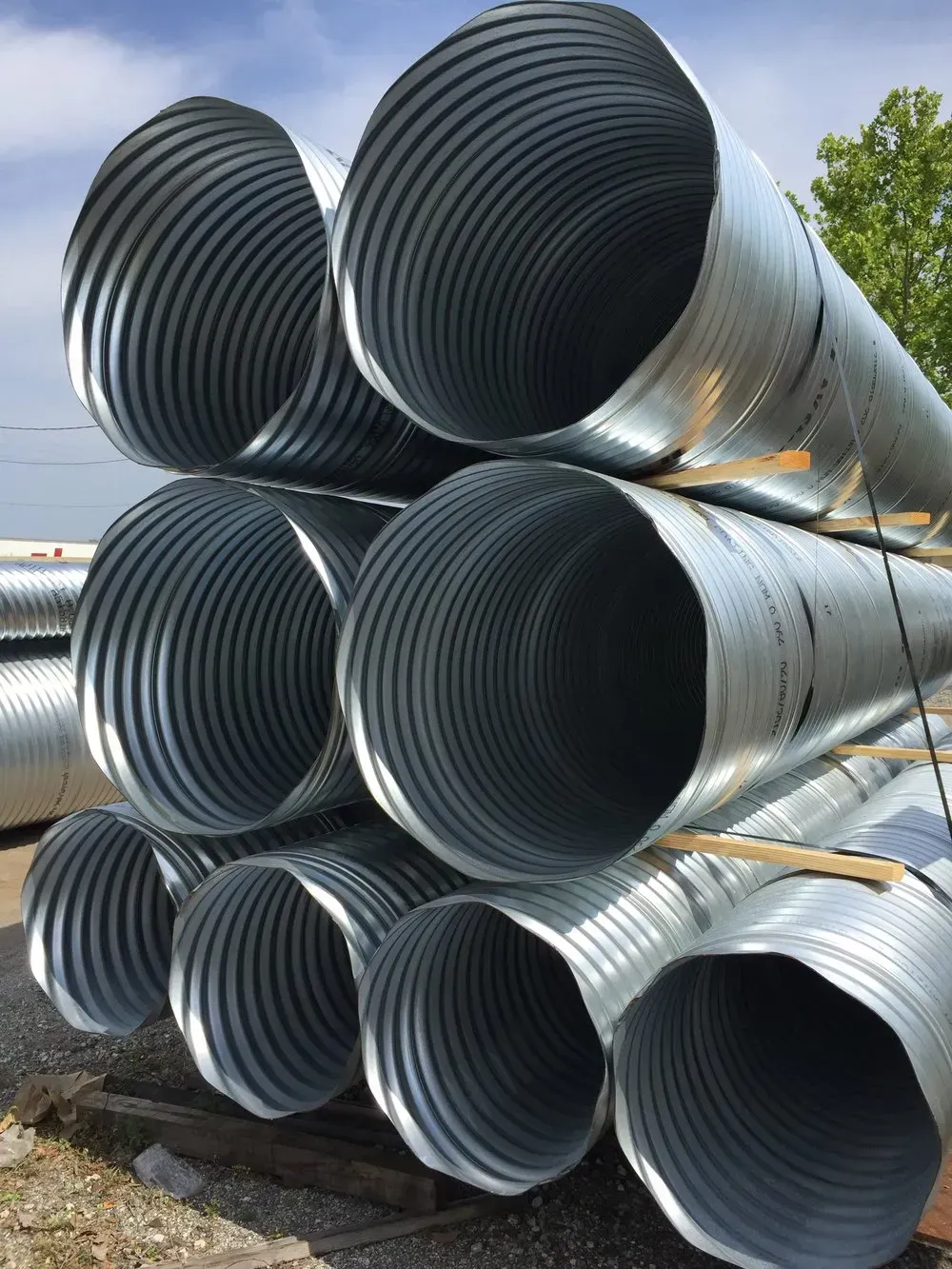 a bunch of metal culverts are stacked on top of each other