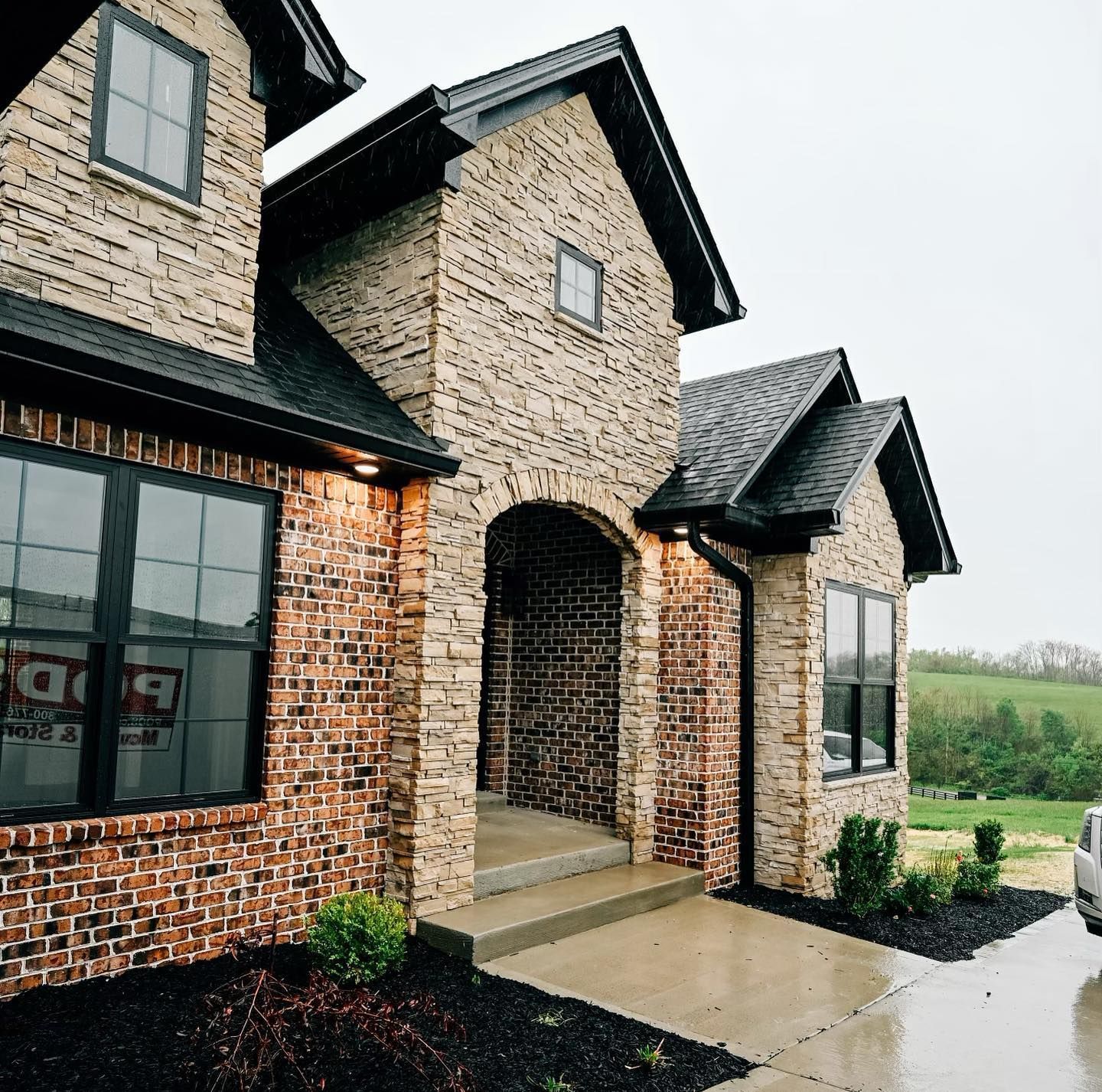 A brick house with a car parked in front of it