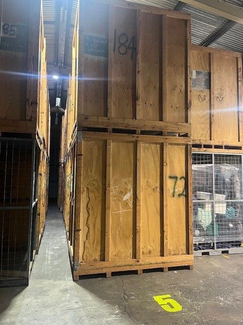 A Warehouse Filled With Lots of Wooden Crates — Ballina Removals & Storage in Alstonville, NSW