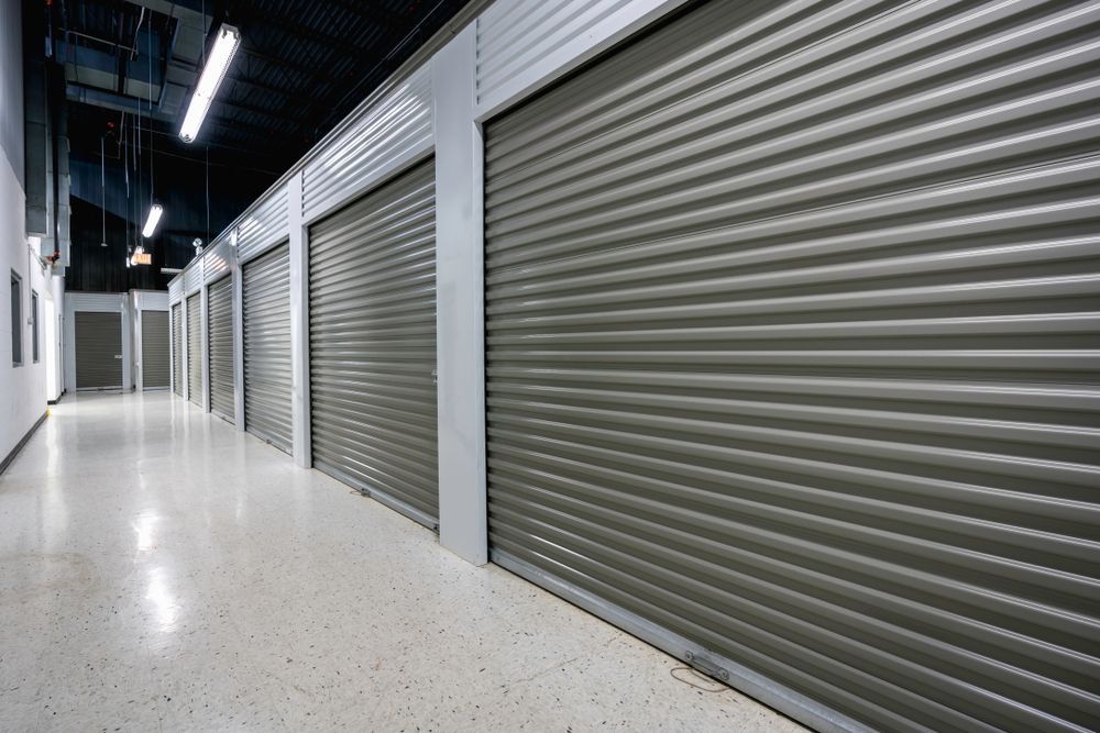An Empty Hallway With a Row of Gray Garage Doors — Ballina Removals & Storage in Alstonville, NSW