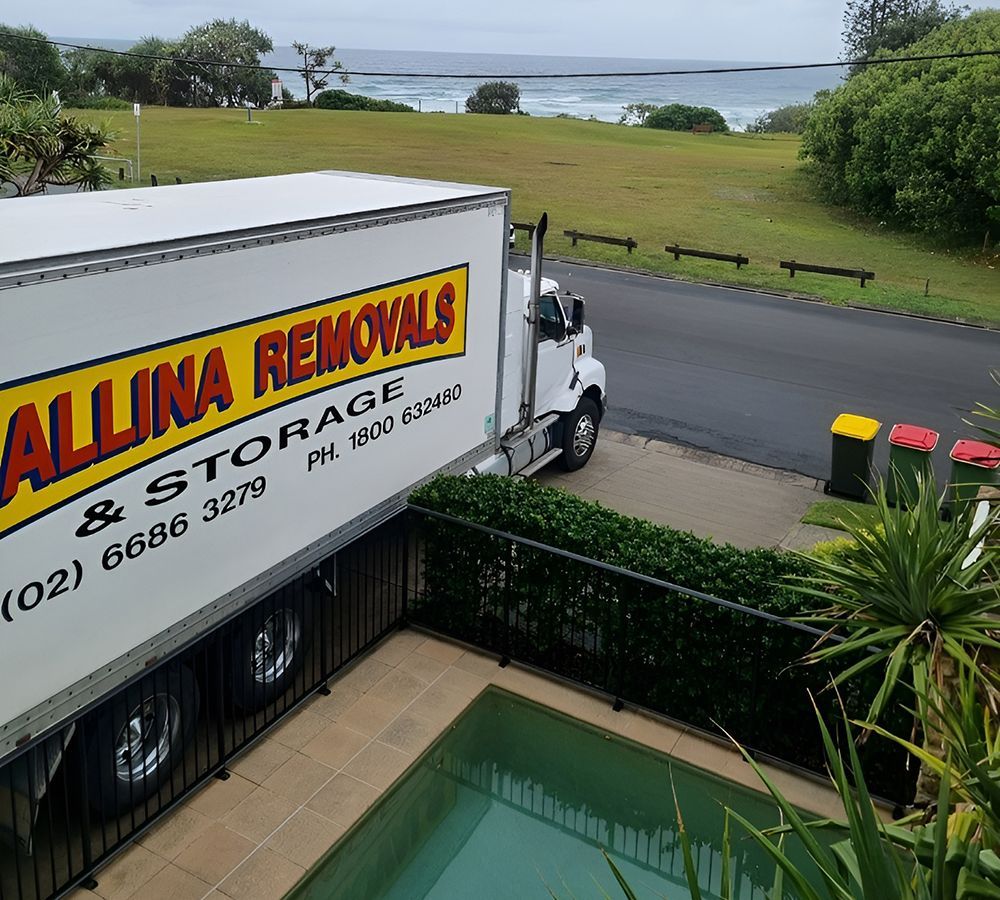 Moving Truck Parked Near a Swimming Pool — Ballina Removals & Storage in Ballina, NSW