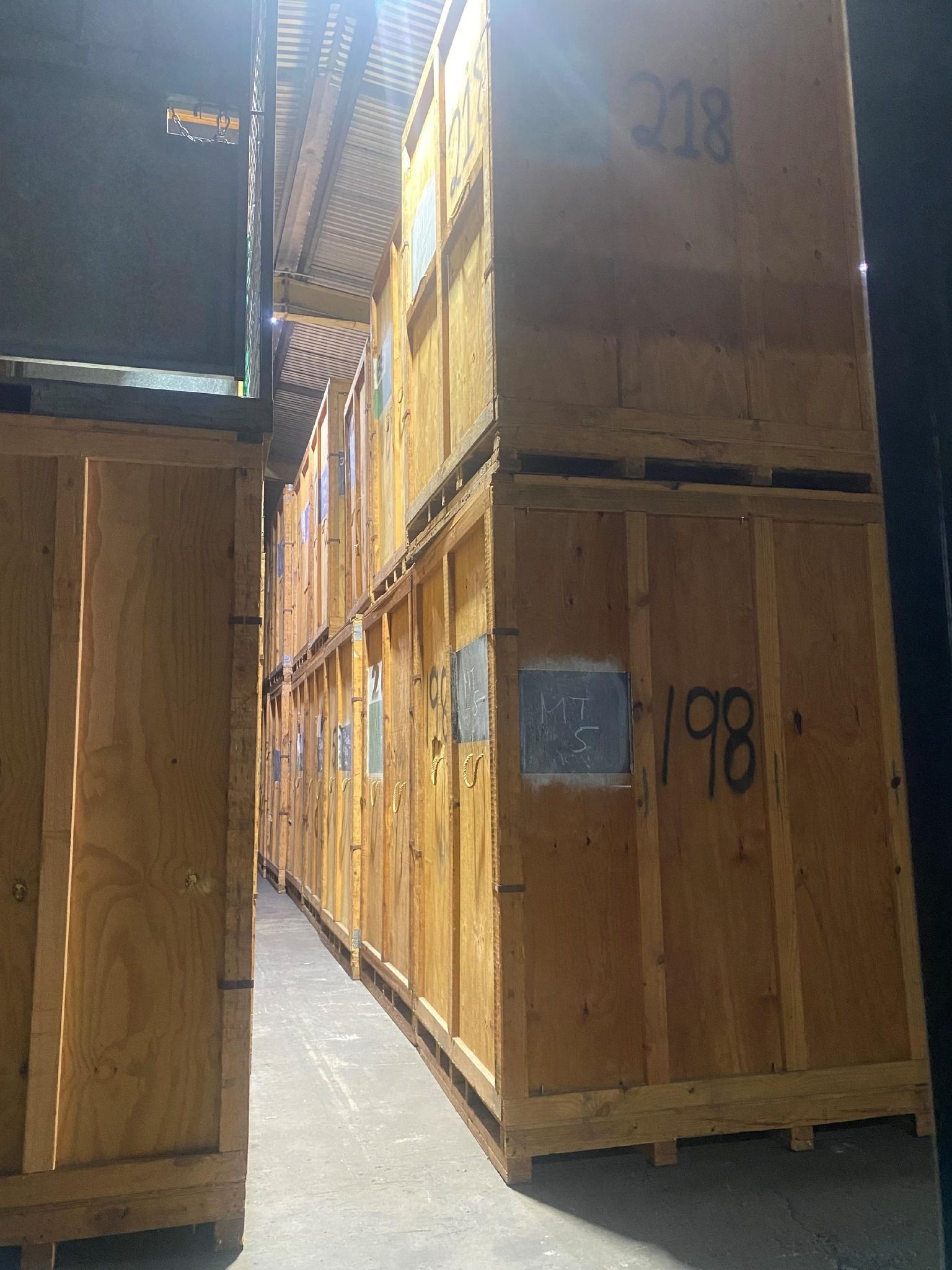 A Warehouse Filled With Lots of Wooden Crates and Boxes — Ballina Removals & Storage in Alstonville, NSW