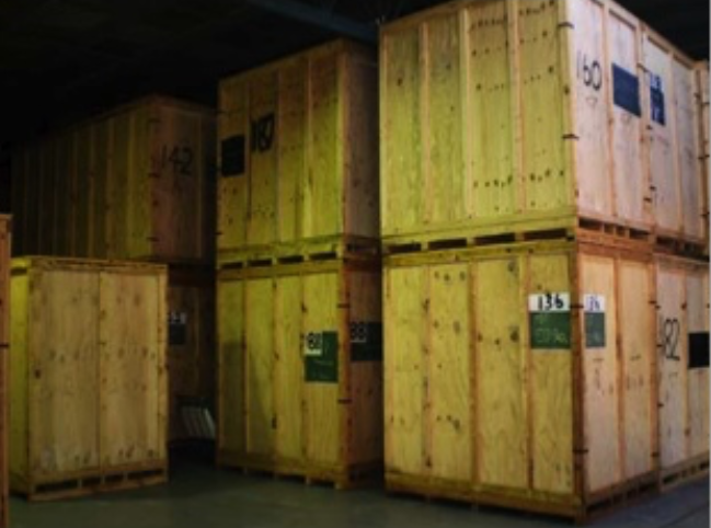 A Bunch of Wooden Crates Are Stacked on Top of Each Other in a Warehouse — Ballina Removals & Storage in Alstonville, NSW
