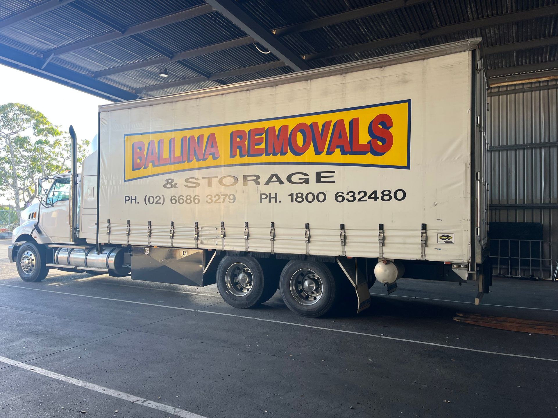 A White truck is parked in a warehouse— Ballina Removals & Storage in Ballina, NSW