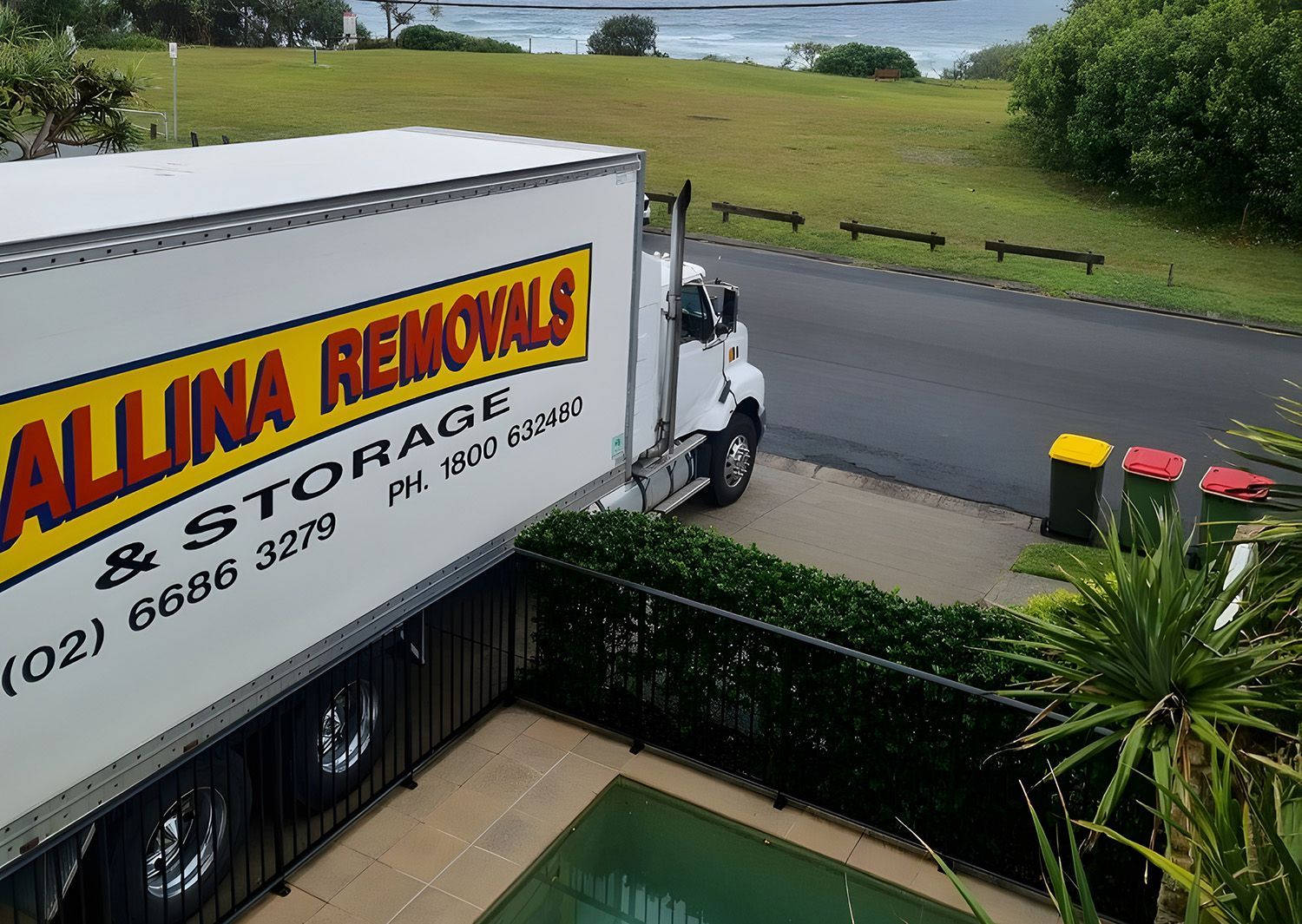A Ballina Removals And Storage Truck Parked Next To A Swimming Pool