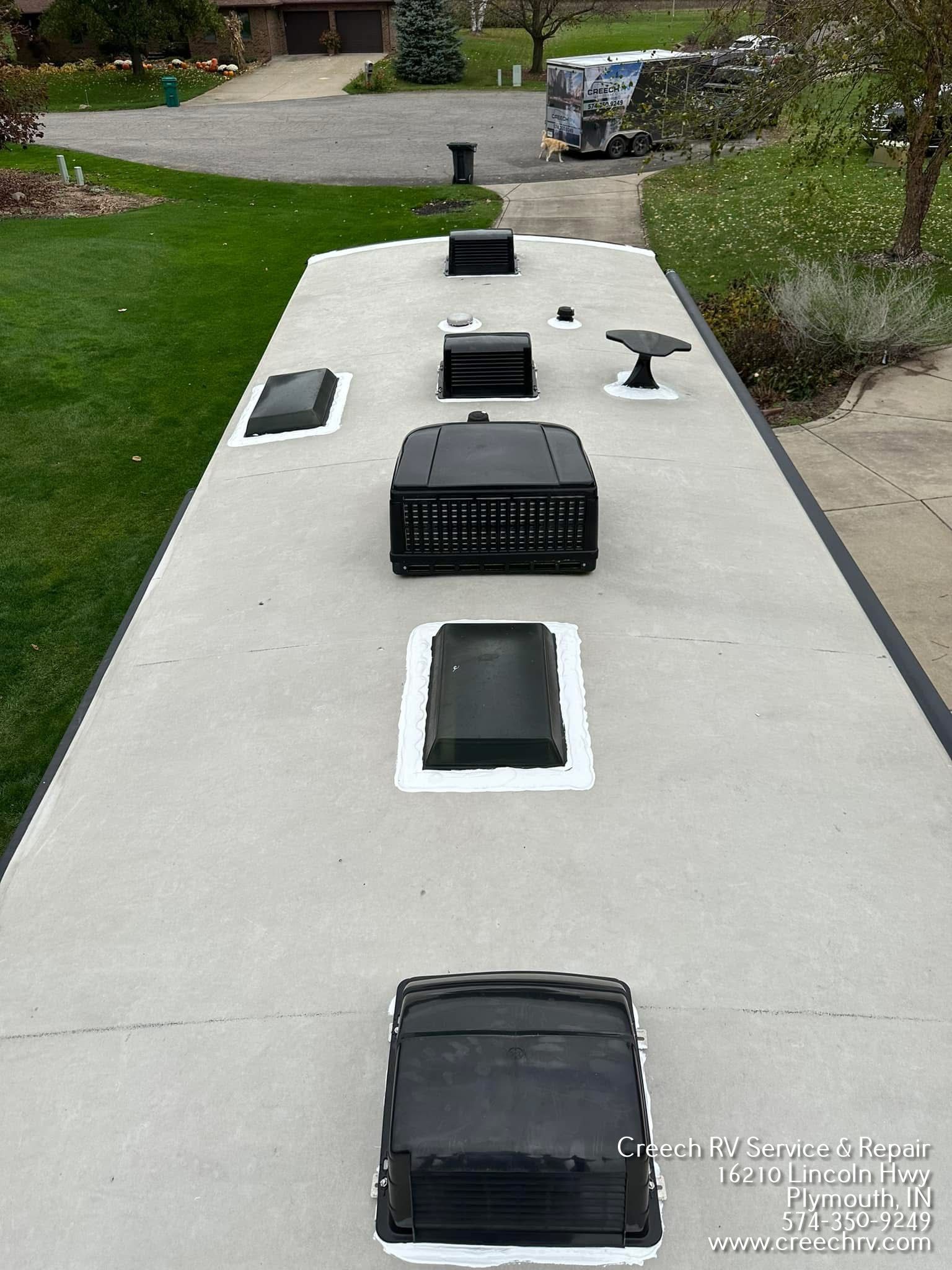 RV roof with vents and air conditioning units, viewed from above.