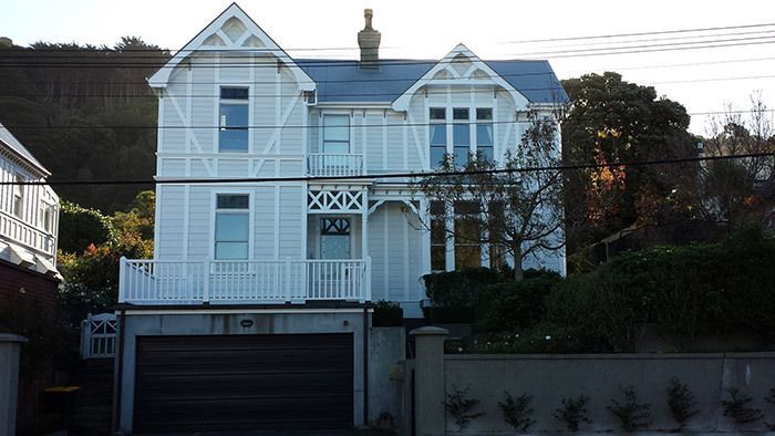 A large white house with a blue roof and a garage — Wellington, NZ — Gavin Chan Decorators Ltd