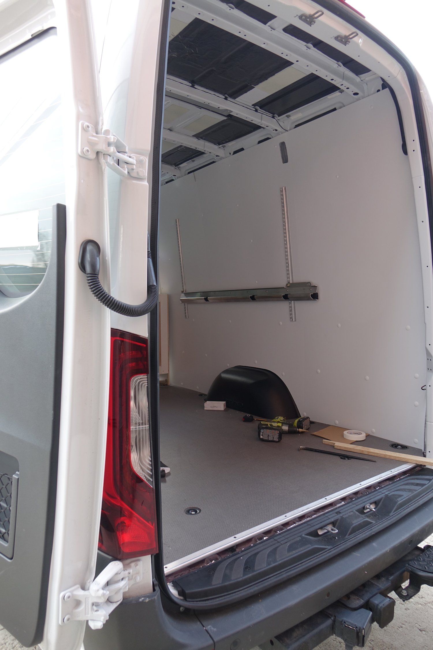 Interior of backend of a Sprinter Van with white walls