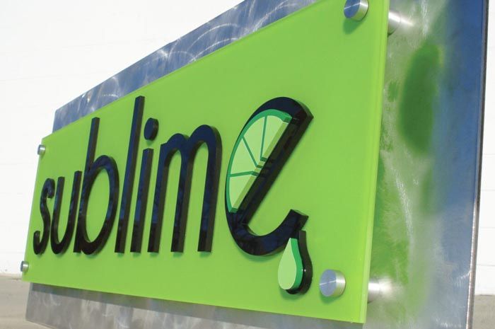 multi layer acrylic and metal sign with top layer stood off the metal base