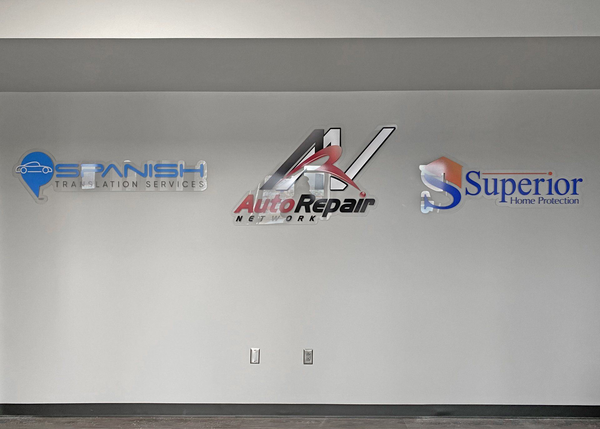 Multiple signs routed from plexiglass with overlaid printed logos