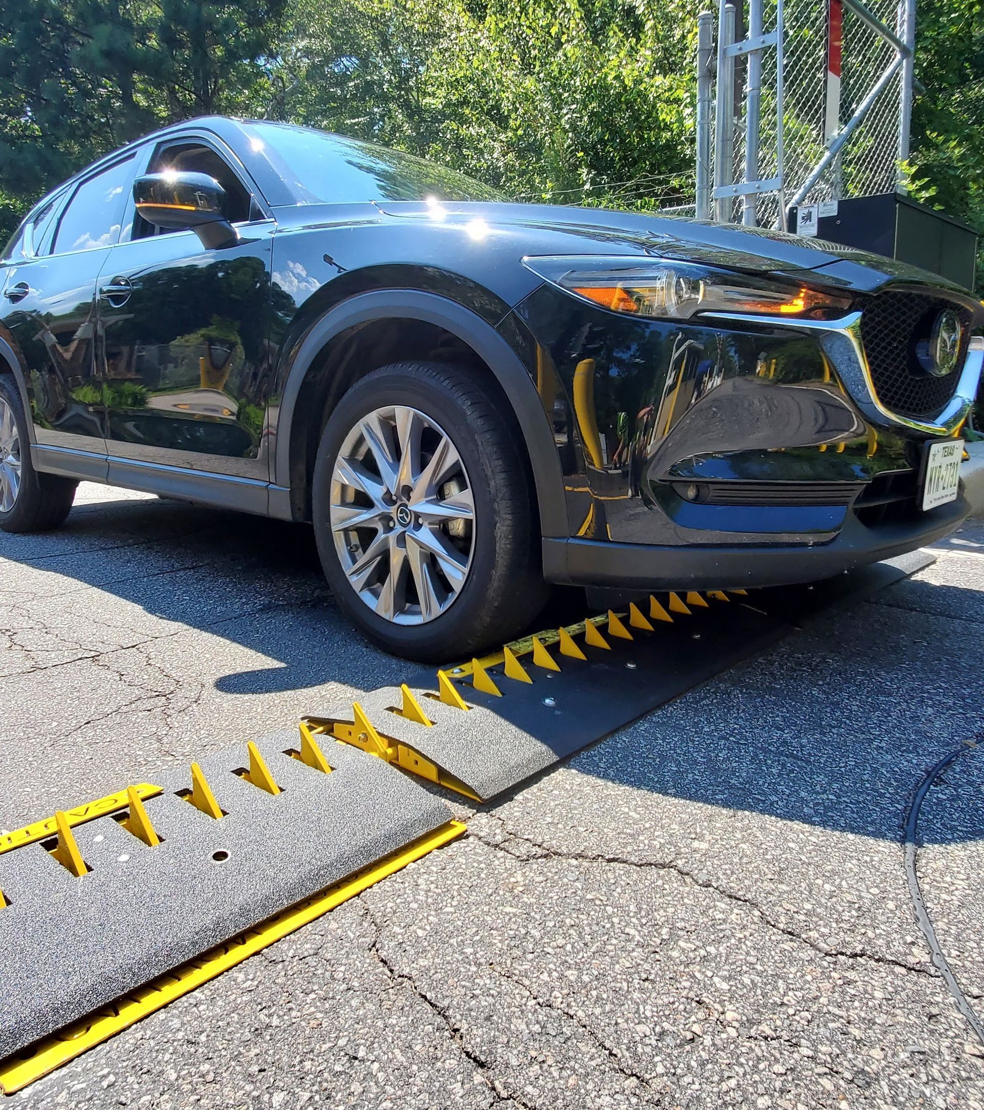 car driving over surface mounted driving strips