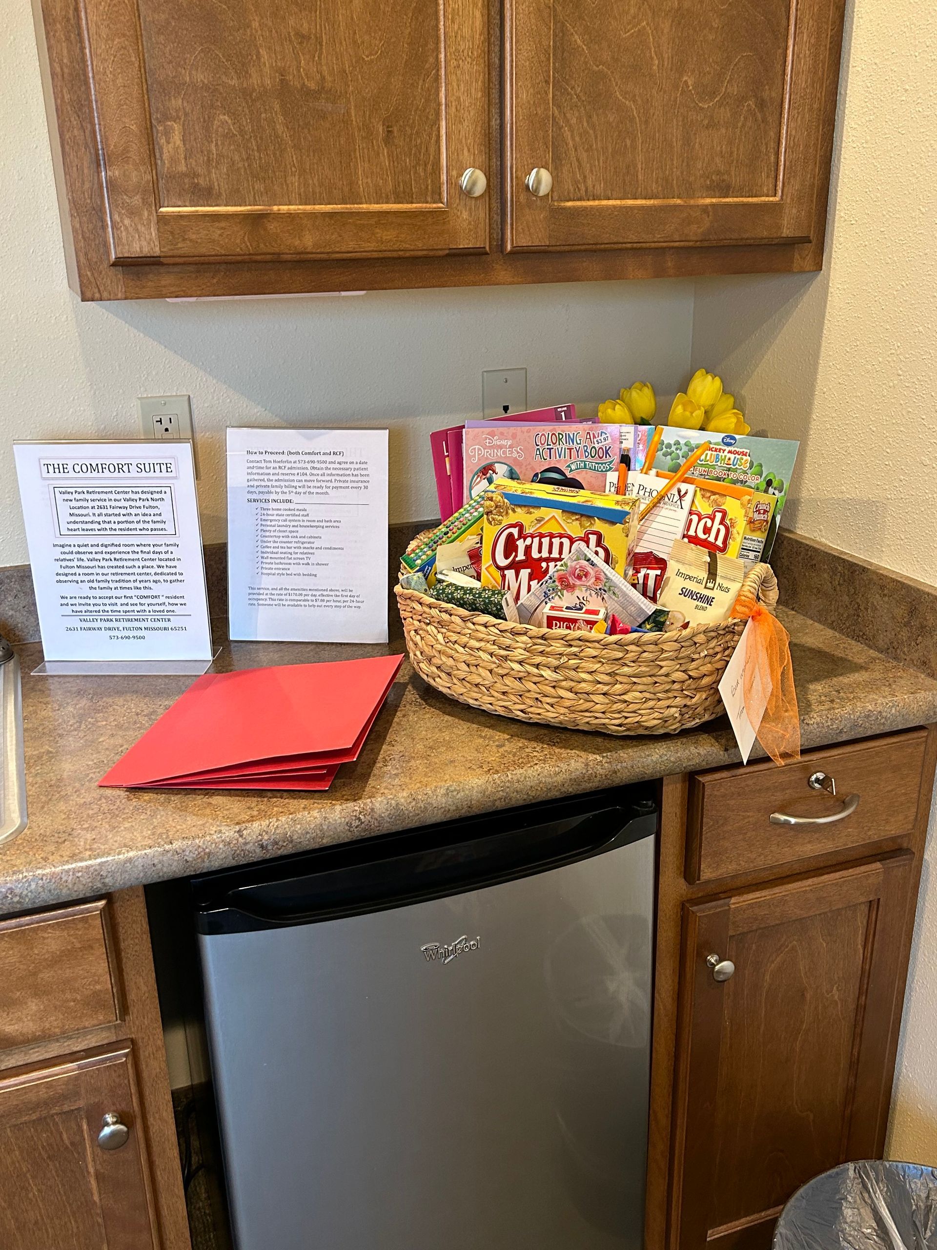 A kitchen counter with a basket of snacks on it.