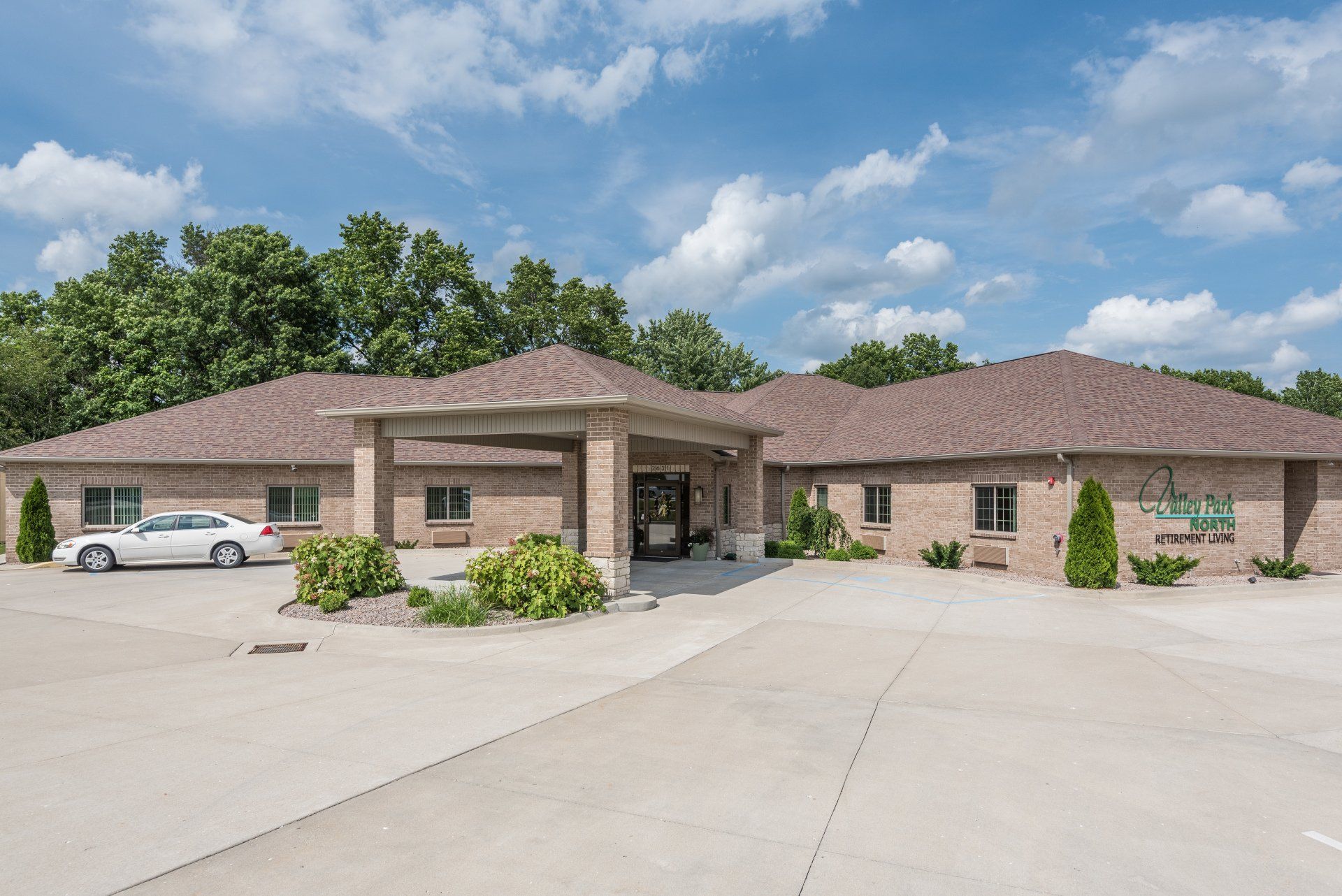 A large brick building with a car parked in front of it.